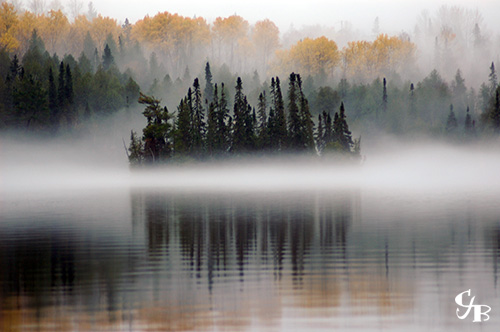 Photo: Fog surrounding an island in the BWCA in northern Minnesota. Photo by Chris J. Benson